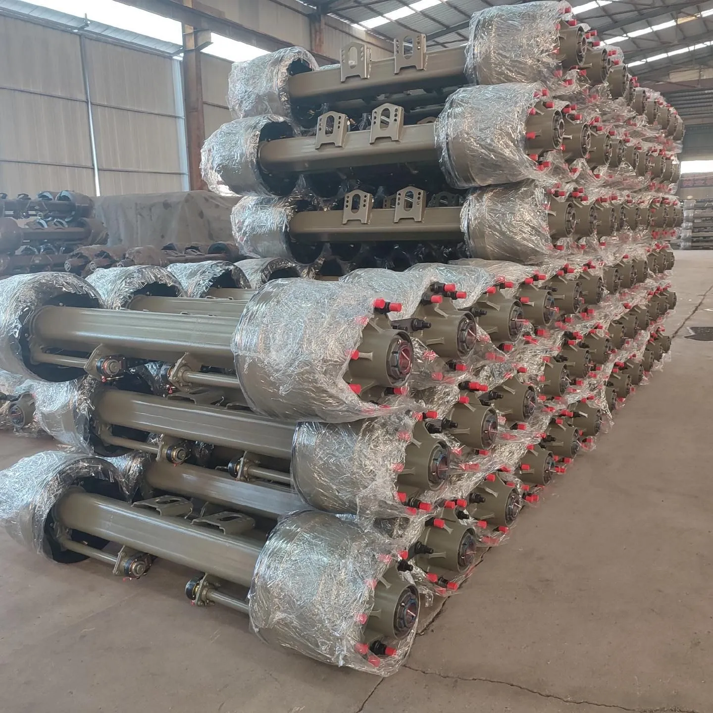 Suspension axle assemblies stacked with wrapped hub ends